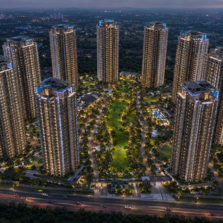 Sattva Varthur Road eight-tower skyline illuminated at night above the central green and SH-35 frontage